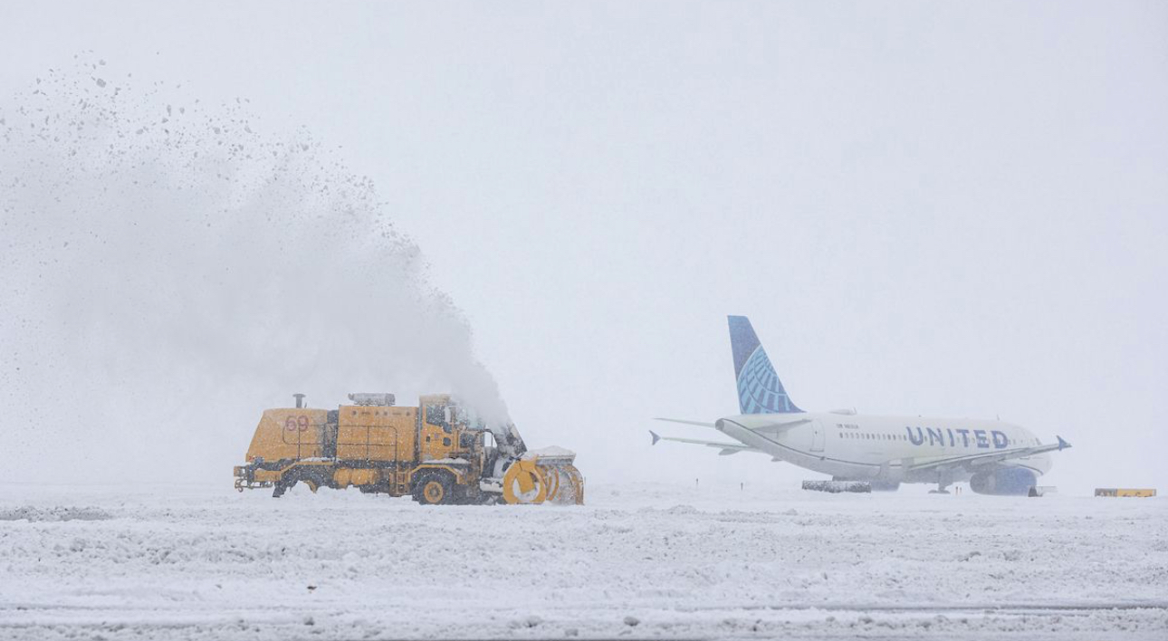 Airfield snow blower clearing runway